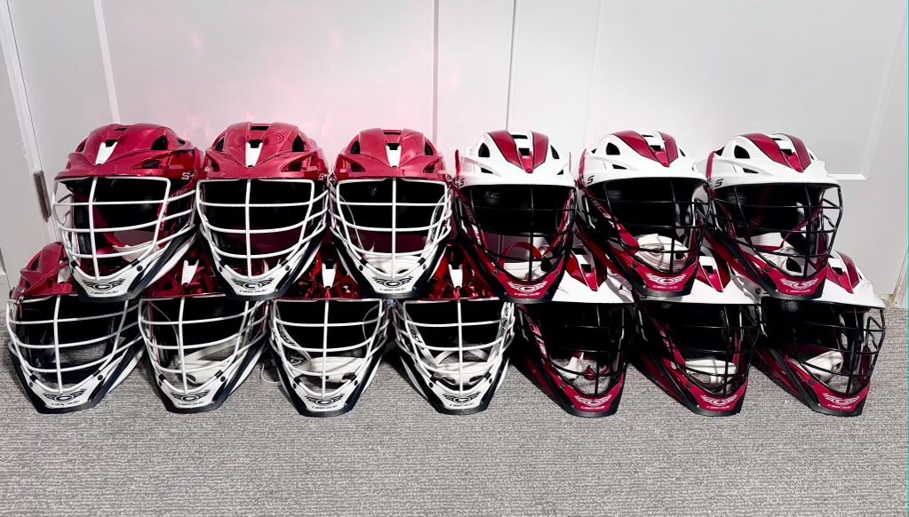 The club's loaner helmets lined up in two rows, red chrome and white