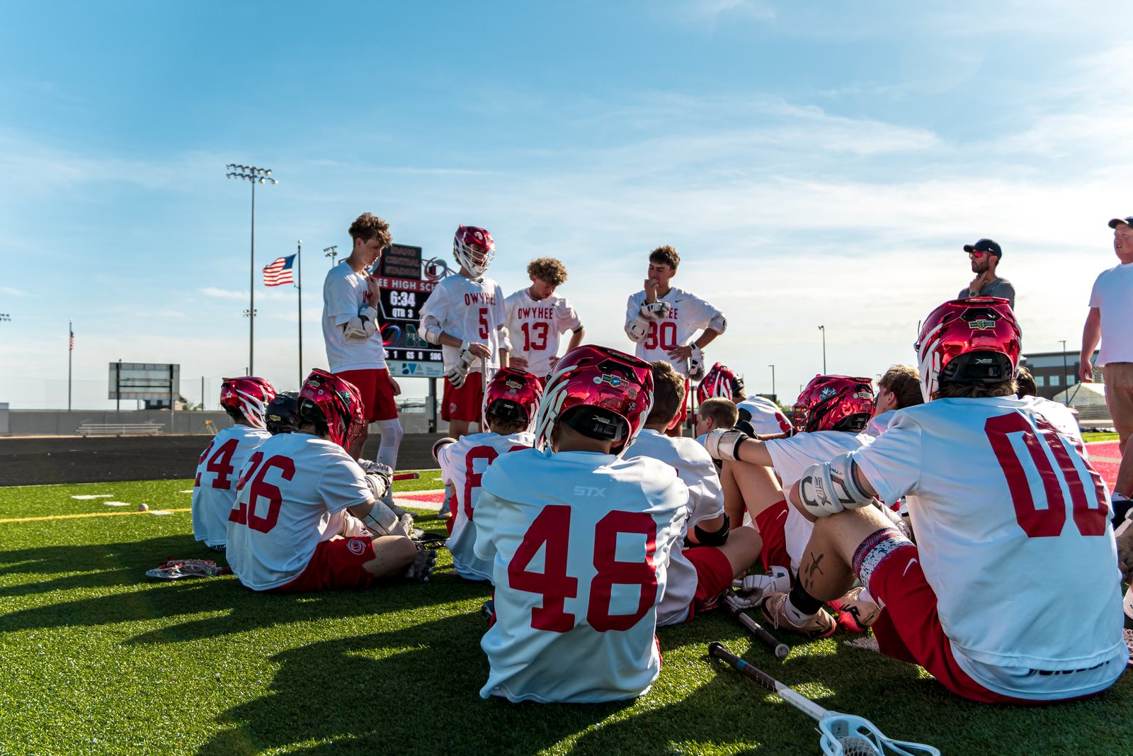 The Storm huddle on the turf during the third quarter at the Owyhee High School football field