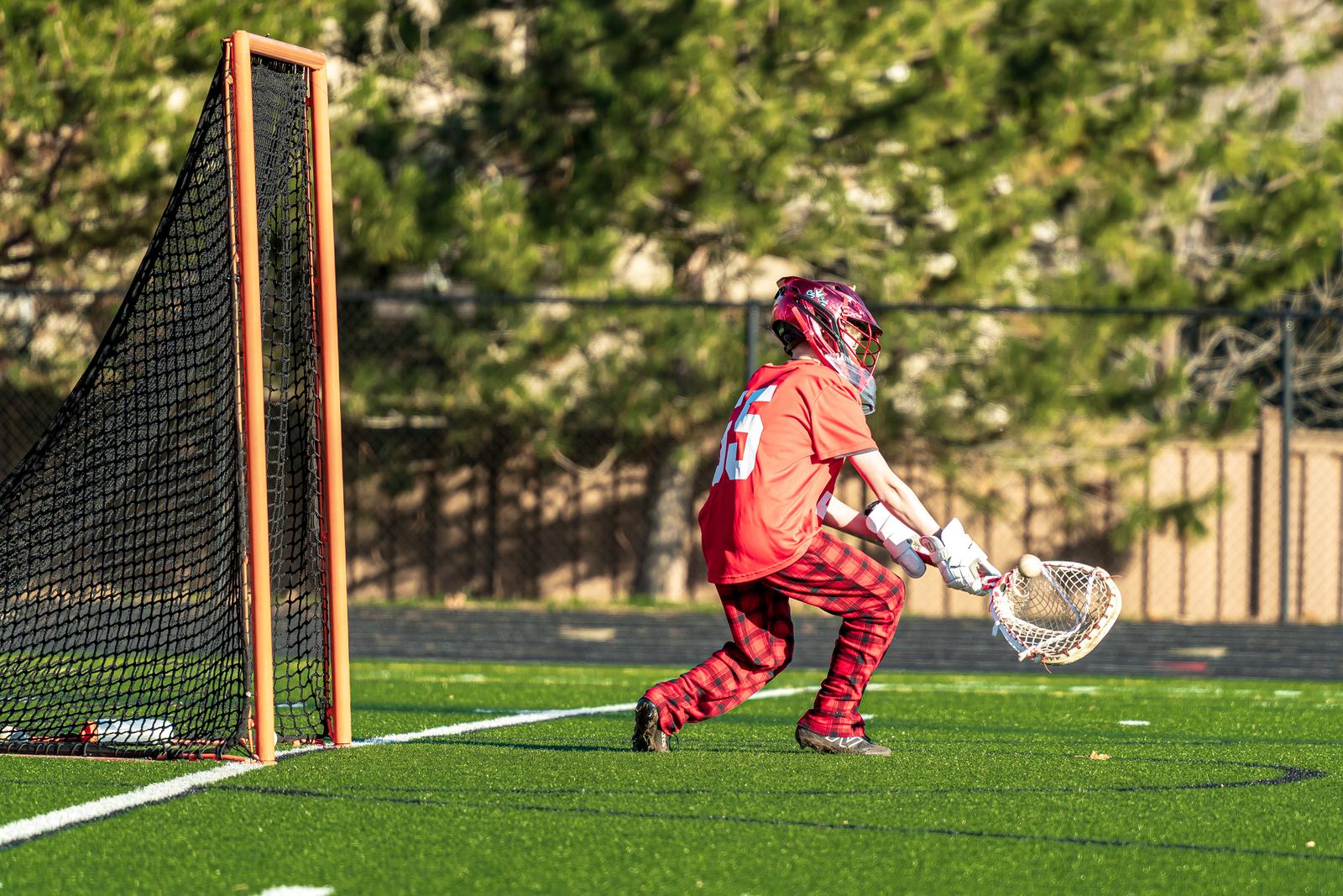 Storm goalie stretching wide to make a save in the crease